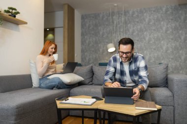 Başarılı iş çifti ev işlerinde birlikte çalışıyor. Takım çalışması konsepti. Aile şirketi kurma..