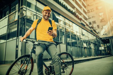 Young man in uniform as a courier delivering food.Food delivery.