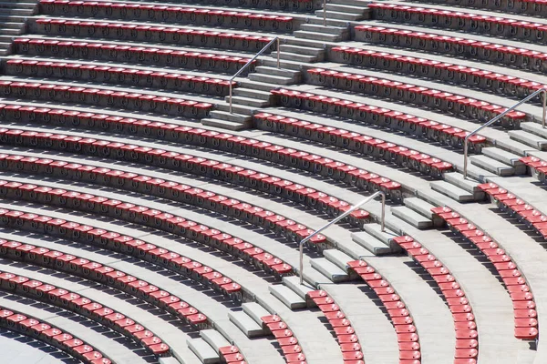 stock image empty plastic red seats on football stadium or amphitheater