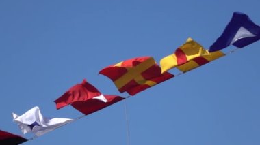 Various nautical flags tied together with rope, Ship flags signals, morse code,