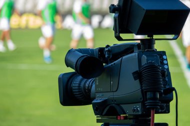 TV camera at the stadium, broadcasting during a football, soccer match