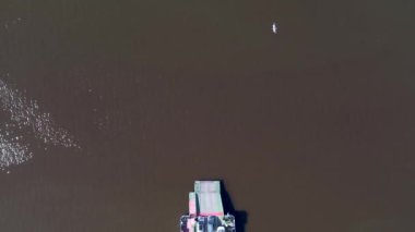 op down view of ferryboat sailing. Ferryboat transferring cars. Ferry transfers cars and passengers to the other side