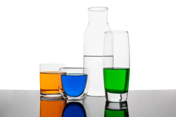 Different types of glasses with different drinks and colors, isolated on white.