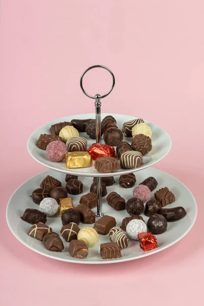 Two section cake stand with chocolate candies. Two tier plate