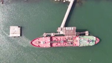 Red tanker ship loading and unloading oil and gas storage at industrial dock port, Business import export petrol and chemical by tanker ship