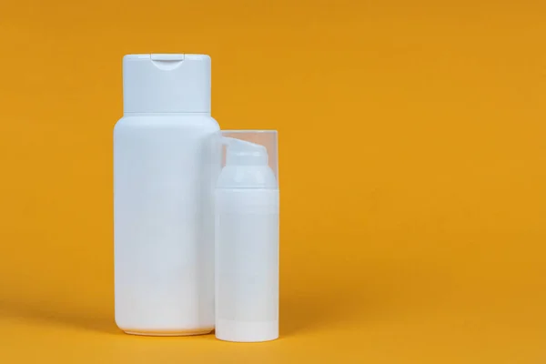 黄色の背景に化粧品の白い容器 スキンケア製品セット 顔と体のケアの概念 — ストック写真