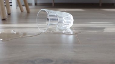Glass of water spilled to the new laminate floor of wood