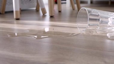 Glass of water spilled to the new laminate floor of wood