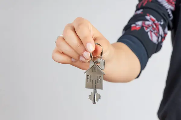 Woman Hand Giving New Metal Key Home Shaped Keychain Isolated — Stock Photo, Image