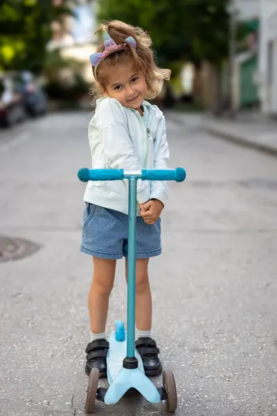 Happy Little Girl Playing His Scooter Outdoor Royalty Free Stock Images