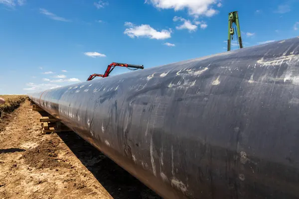 stock image Gas and oil pipeline construction. Pipes welded together. Big pipeline is under construction. Cloudy sky