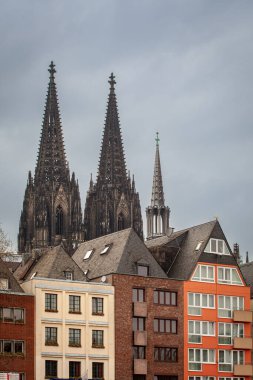 View of old colorful houses and the Roman Catholic Gothic Cathedral Kolner Dom in Cologne, Germany clipart