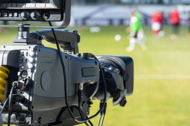 TV camera at the stadium, broadcasting during a football, soccer match