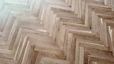 Yeni kaplama döşeme. Kahverengi ahşap desenli işlenmiş parke.