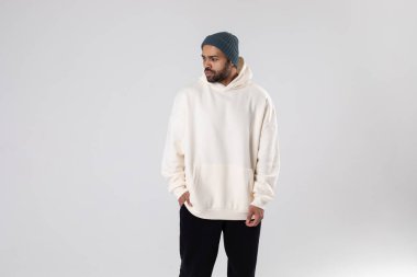 African American man in a knitted hat and white oversized hoodie. Mock-up.