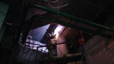 metal welding in darkness under the ceiling shooting from below. High quality FullHD footage