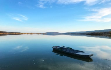 Serbian border with Romania on the Danube river coastline panorama and a small fishing boat clipart