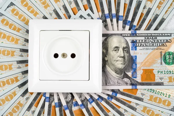 stock image White socket over many 100 dollars banknotes as background. Increasing prices for electricity in the world. High energy cost, world energy and power industry crisis concept