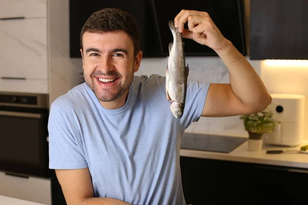 Portret Przystojnego Młodego Mężczyzny Surową Rybą Kuchni — Zdjęcie stockowe