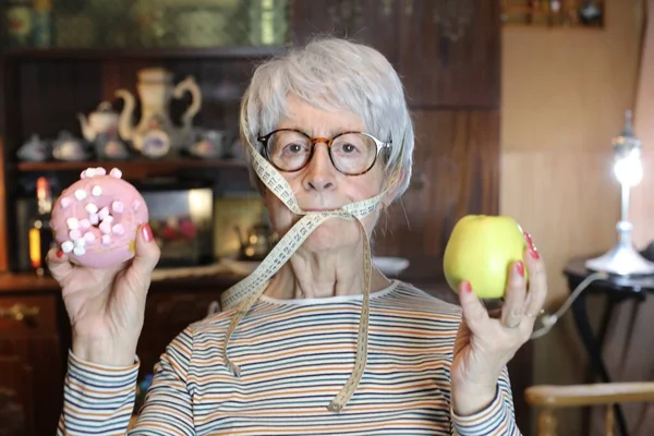 Close Portrait Mature Woman Doughnut Apple Measuring Tape Mouth Home — Stok fotoğraf