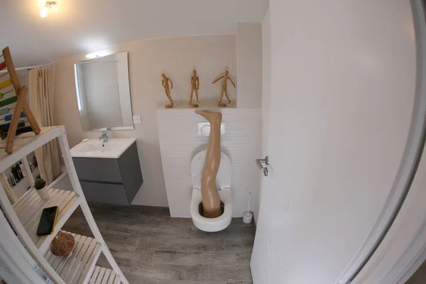 Wide Angle Shot Plastic Leg Sticking Out Toilet — 스톡 사진