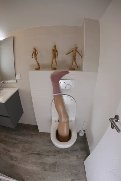 Wide Angle Shot Plastic Leg Sticking Out Toilet — 스톡 사진