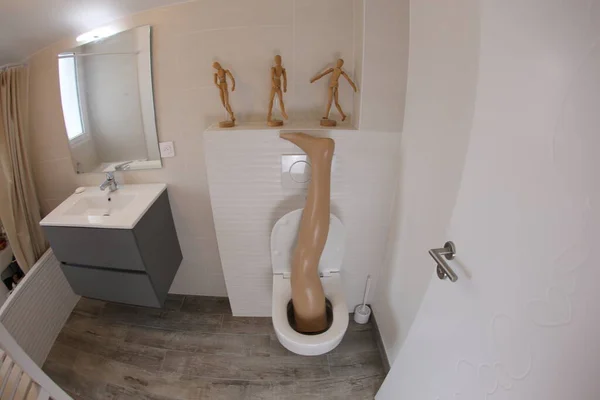 Wide Angle Shot Plastic Leg Sticking Out Toilet — 스톡 사진