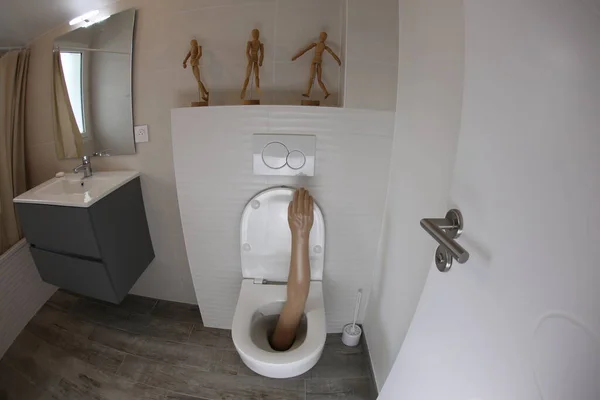 Wide Angle Shot Plastic Arm Sticking Out Toilet — 스톡 사진