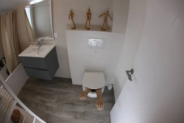 Wide Angle Shot Plastic Arms Sticking Out Toilet — 스톡 사진