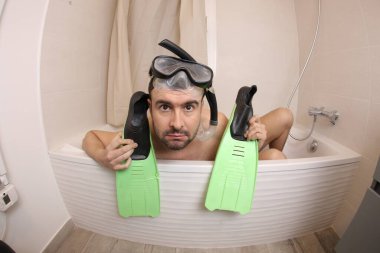 wide angle shot of handsome young man with snorkeling equipment in bath