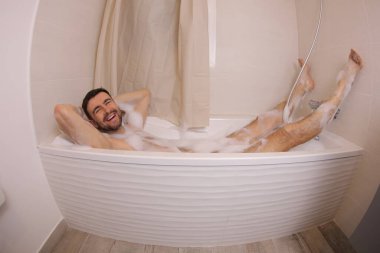 wide angle shot of handsome young man in bath