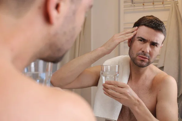 浴室の鏡の前に片頭痛を持つハンサムな若い男の肖像画 — ストック写真