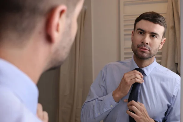 stock image portrait of handsome young man with shirt and tie in front of mirror in bathroom