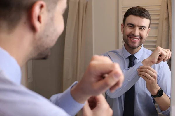 stock image portrait of handsome young man with shirt and tie in front of mirror in bathroom