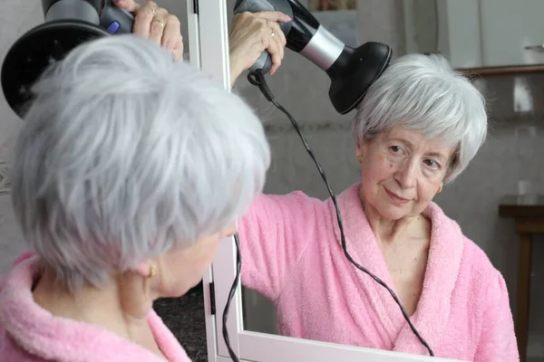 Banyoda Aynanın Önünde Saç Kurutma Makinesi Olan Olgun Bir Kadının — Stok fotoğraf