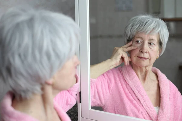 stock image close-up portrait of mature woman in front of mirror in bathroom