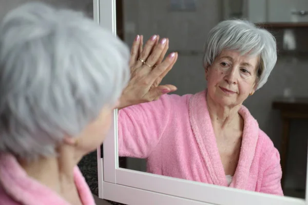 stock image close-up portrait of mature woman in front of mirror in bathroom