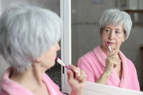Close Portrait Mature Woman Brushing Teeth Front Mirror Bathroom — Stock Photo, Image