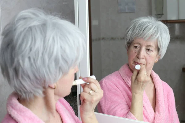 Close Portrait Mature Woman Applying Lip Balm Front Mirror Bathroom — Stock Photo, Image