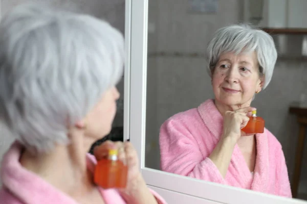 Close Portrait Mature Woman Applying Perfume Front Mirror Bathroom — Stock Photo, Image