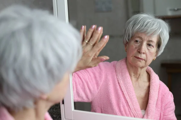 Stock image close-up portrait of mature woman in front of mirror in bathroom