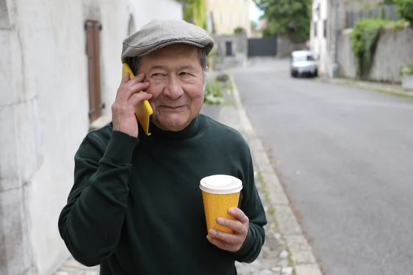 stock image portrait of handsome senior man in stylish clothes on city street