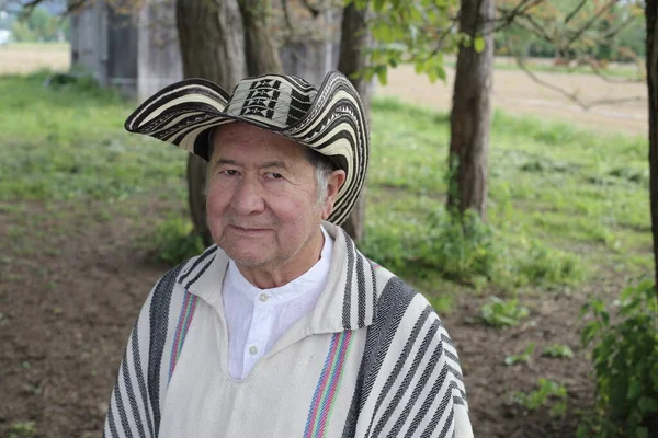 stock image portrait of handsome senior man in traditional Colombian clothes on nature