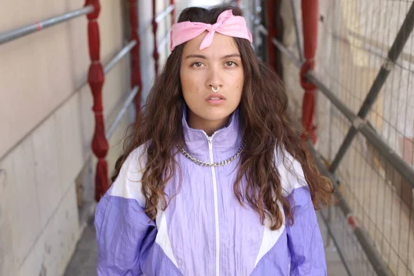 stock image portrait of beautiful young woman in athletic clothing on city street