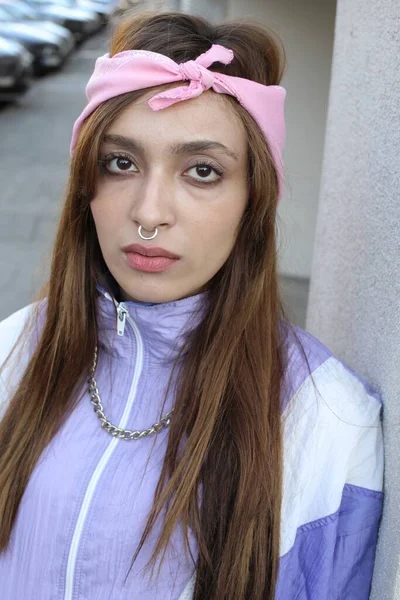 stock image Portrait of stylish hipster woman wearing headband and piercing on urban background