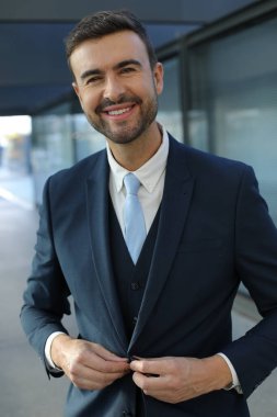 Şehir caddesinde takım elbiseli yakışıklı genç işadamının portresi.