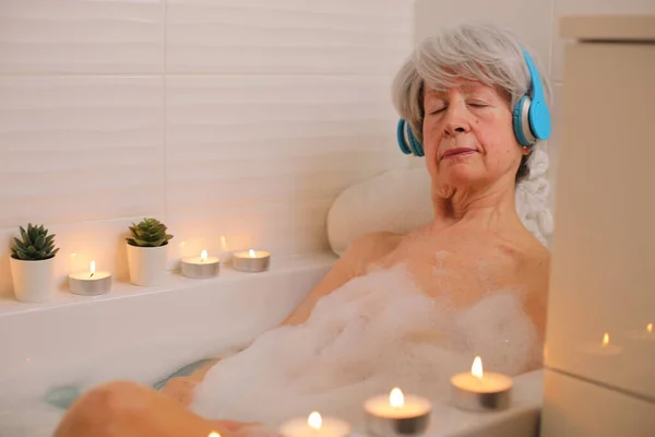 Portrait Happy Senior Woman Relaxing Bathtub Soap Bubbles Listening Music — Stock Photo, Image