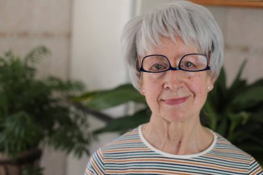 Senior woman wearing her eyeglasses upside down clipart
