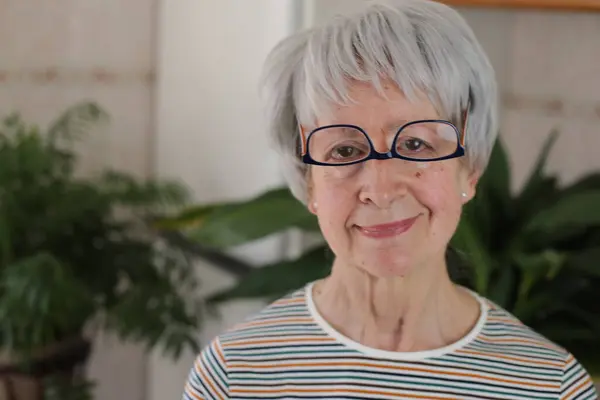 stock image Senior woman wearing her eyeglasses upside down