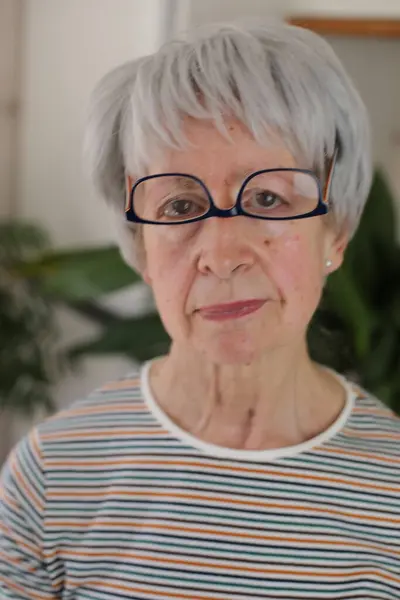 stock image Senior woman wearing her eyeglasses upside down